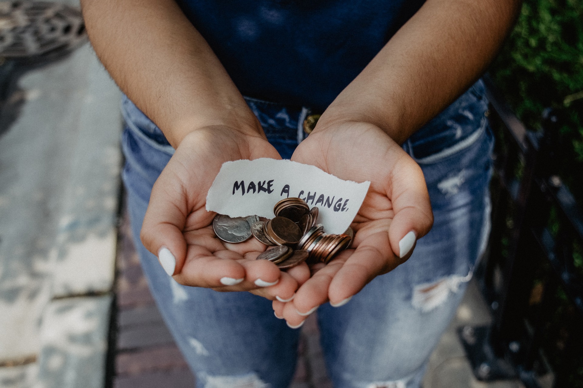 A small handwritten note stating 'make a change' with a variety of coins.