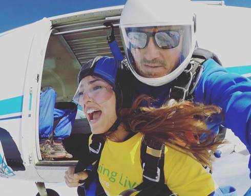 Fundraiser taking part in a skydive, wearing a Wiltshire Air Ambulance yellow t-shirt