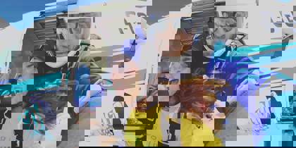 Fundraiser taking part in a skydive, wearing a Wiltshire Air Ambulance yellow t-shirt Fundraiser taking part in a skydive, wearing a Wiltshire Air Ambulance yellow t-shirt