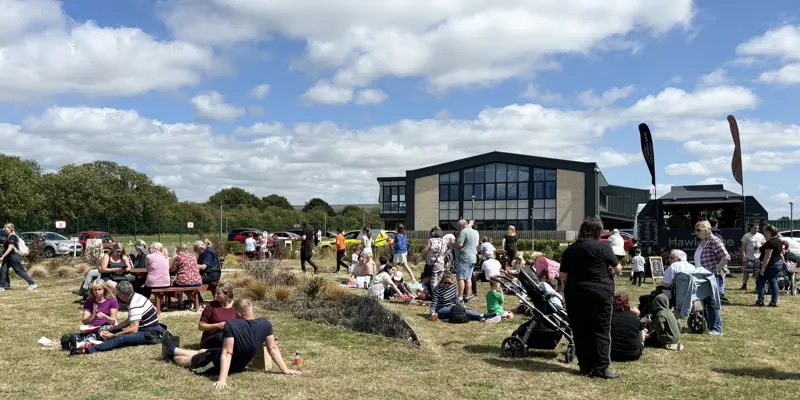A group of people lounging in the sun at an air ambulance airbase