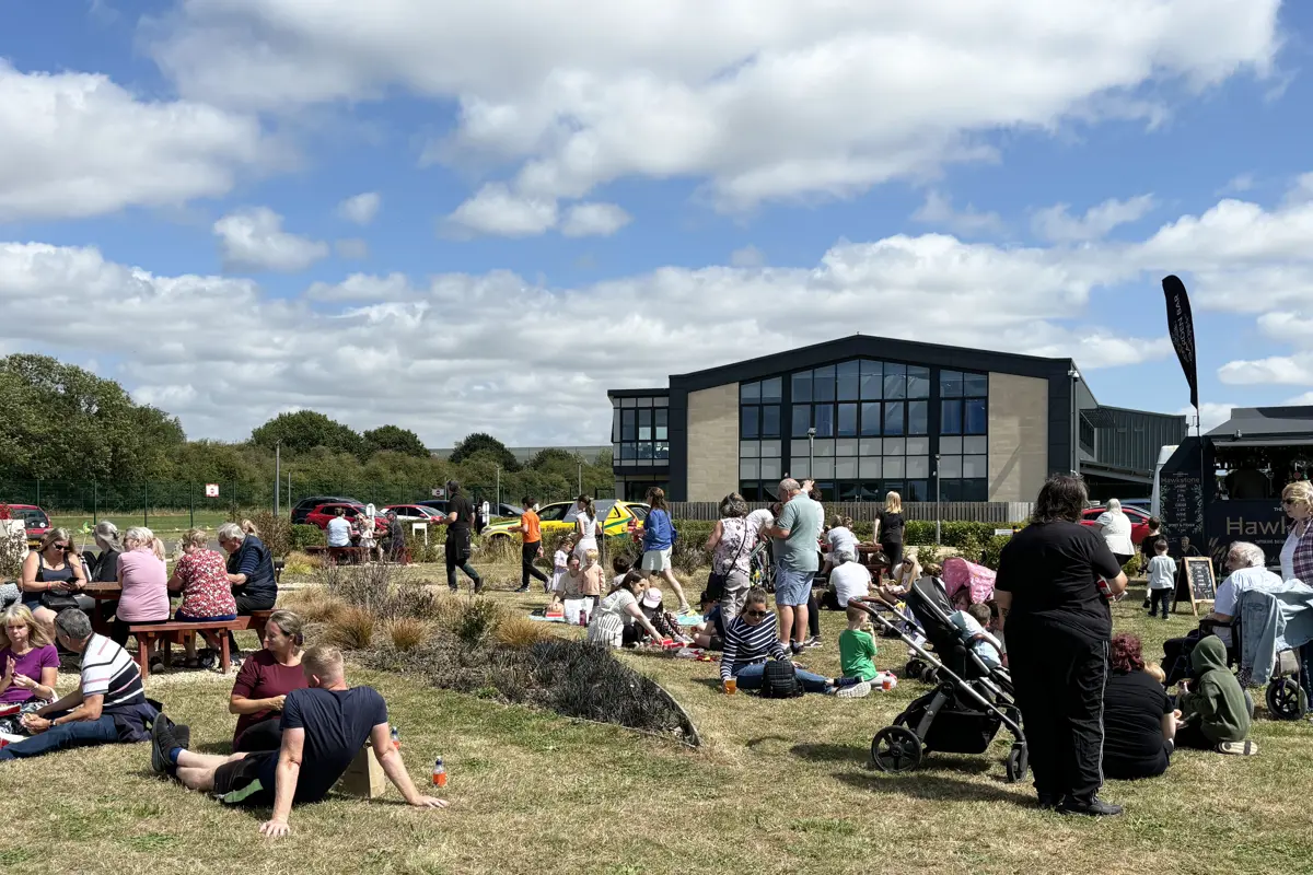 A group of people lounging in the sun at an air ambulance airbase