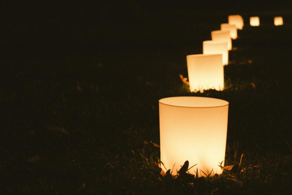 A row of candles on grass