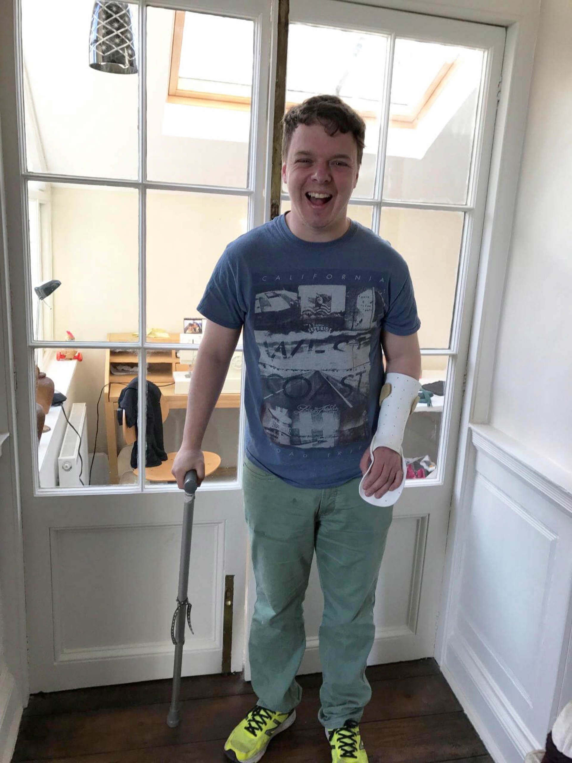 A former patient at home with their arm in a brace