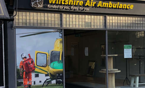 The WAA charity shop window with new vinyl sticker.