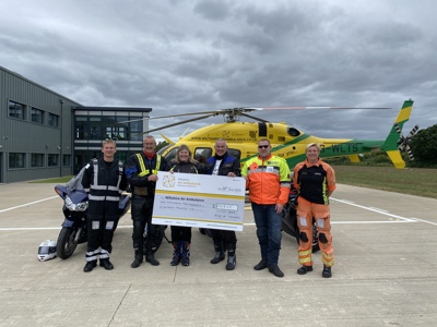 A cheque presentation with the NHS Ride of Thanks bikers with Pilot Fin Collins and Paramedic Emma Thompson in front of the Wiltshire Air Ambulance helicopter A cheque presentation with the NHS Ride of Thanks bikers with Pilot Fin Collins and Paramedic Emma Thompson in front of the Wiltshire Air Ambulance helicopter