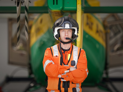 Critical care paramedic Craig Wilkins wearing a flight helmet in front of the airbase hanger and tail rotor of the Wiltshire Air Ambulance helicopter. Critical care paramedic Craig Wilkins wearing a flight helmet in front of the airbase hanger and tail rotor of the Wiltshire Air Ambulance helicopter.