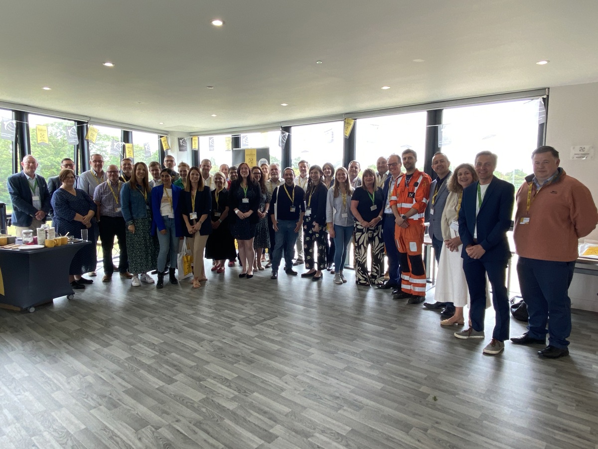 A large group of people smiling at the camera for the launch of The Business Club