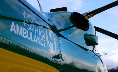 Wiltshire and Bath Air Ambulance helicopter showing logo and rotor blades