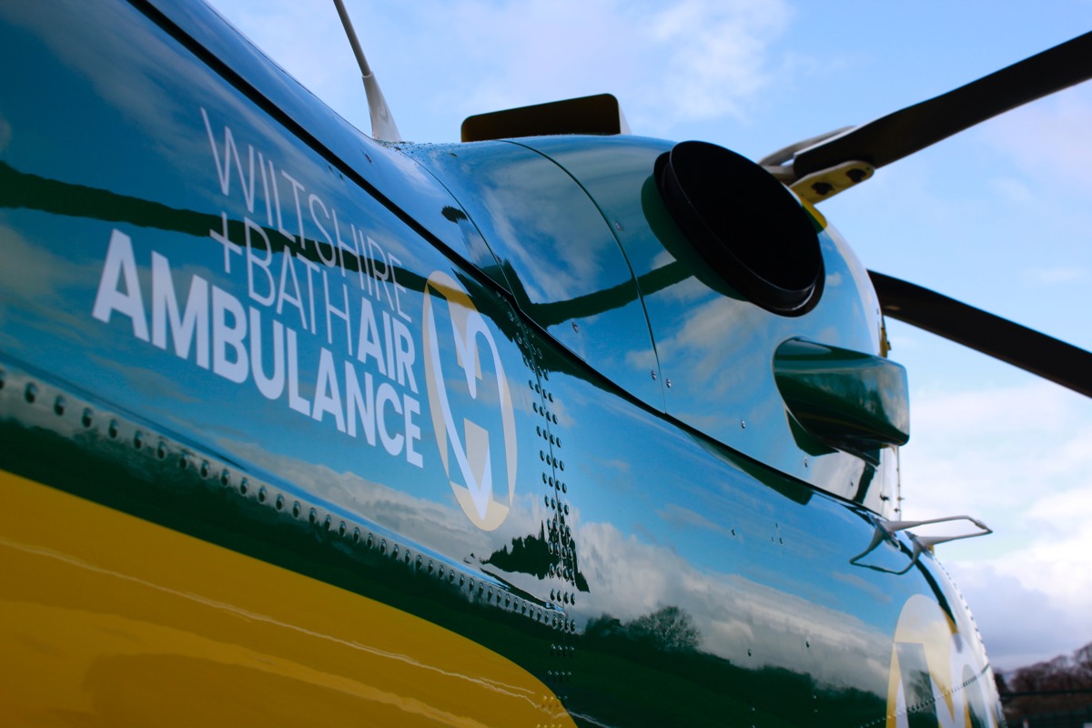 Wiltshire and Bath Air Ambulance helicopter showing logo and rotor blades