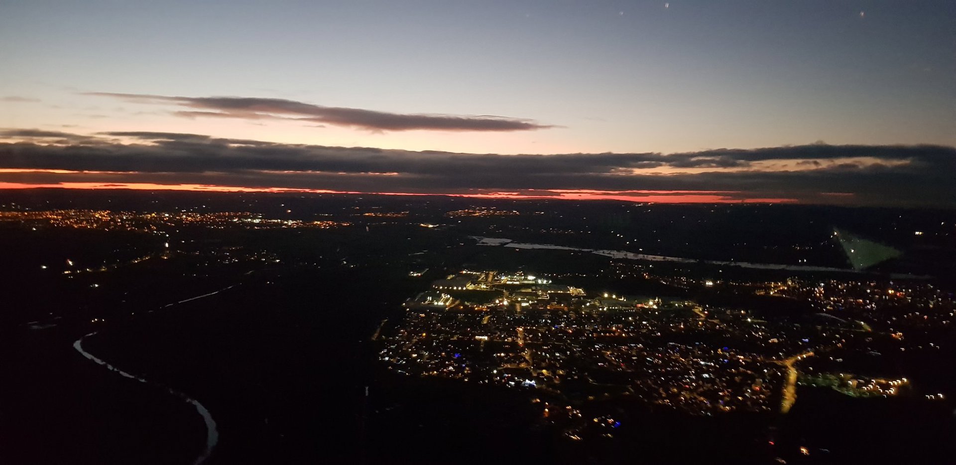 A photo of a town from above with a sunset A photo of a town from above with a sunset