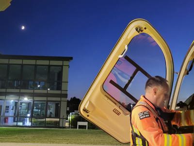 Paramedic Rich Miller putting something in the front of the Wiltshire Air Ambulance helicopter