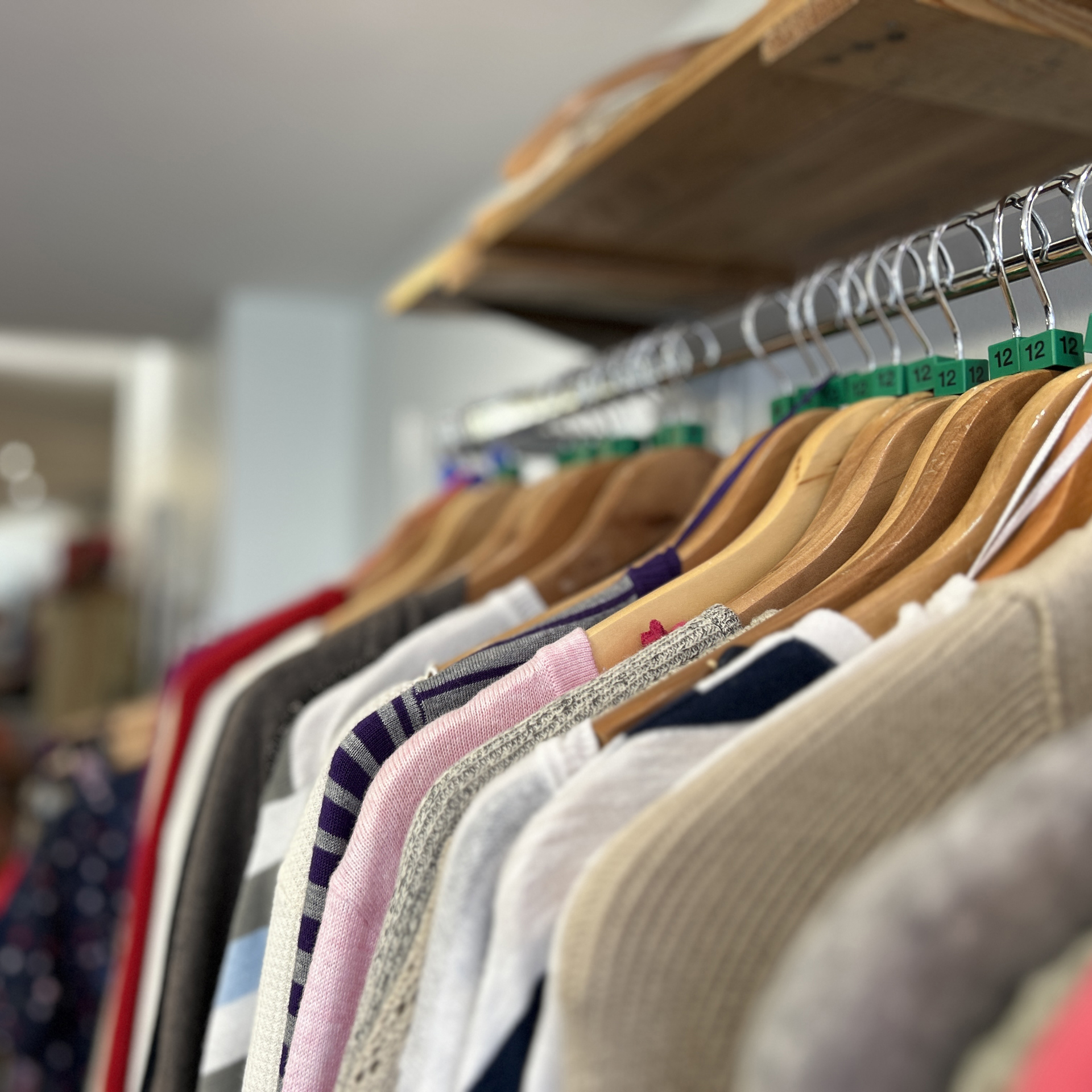 A rail of clothing for sale in the Devizes Charity Shop