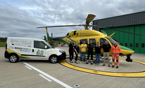 Mike Land with the 24hr van pull vehicle parked on the helipad next to the WAA helicopter