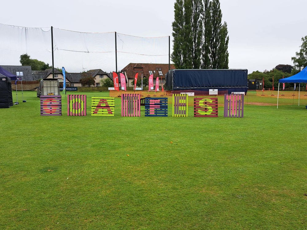 Pallets in a festival field with GOATFEST displayed on them in various colours