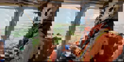 A critical care doctor in an air ambulance, looking out the window to see a rainbow A critical care doctor in an air ambulance, looking out the window to see a rainbow