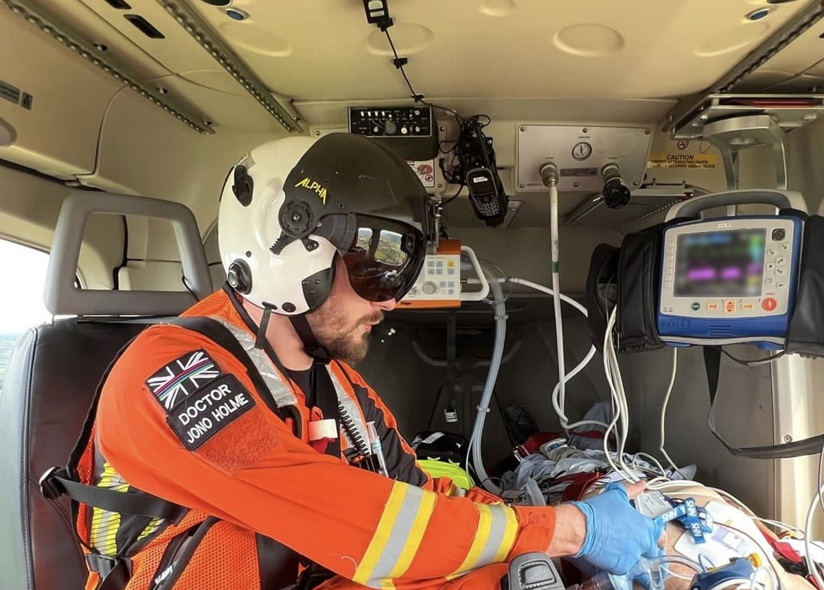 Dr Jono Holme delivering drugs to a patient in flight Dr Jono Holme delivering drugs to a patient in flight