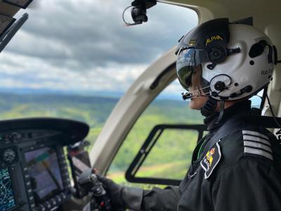 Pilot Rob wearing flight helmet, flying Wiltshire Air Ambulance's helicopter