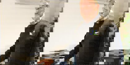 A man posing with a printer A man posing with a printer